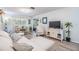 Bright living room featuring an abundance of natural light, modern furniture, and sleek flooring at 1159 Montrose Pl, Dunedin, FL 34698