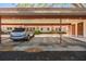 Open-air parking features assigned spots with an attached structure at 1159 Montrose Pl, Dunedin, FL 34698