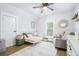 Charming bedroom with a white metal bed, a ceiling fan, and a window with shutters at 1221 E Paris St, Tampa, FL 33604