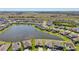 Aerial view of the community with lush green space, water views, and neighborhood streets at 13822 Carlow Park Dr, Riverview, FL 33579