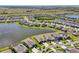 Community aerial view showcasing the lakefront homes and the lush surrounding landscape at 13822 Carlow Park Dr, Riverview, FL 33579