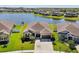 Aerial view showcasing a home, its landscaping, and waterfront location at 13822 Carlow Park Dr, Riverview, FL 33579