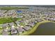 Community aerial view showcasing amenities such as a pool and clubhouse near the lake at 13822 Carlow Park Dr, Riverview, FL 33579