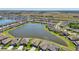 Panoramic aerial view of a residential community on a lake with green spaces at 13822 Carlow Park Dr, Riverview, FL 33579