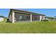 Expansive backyard with a screened-in patio and lush green lawn at 13822 Carlow Park Dr, Riverview, FL 33579