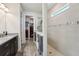 Bright bathroom with wood tile flooring, granite countertop, glass shower, and walk-in closet at 13822 Carlow Park Dr, Riverview, FL 33579