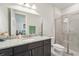 Bathroom featuring granite countertop vanity, updated fixtures, and glass enclosed shower at 13822 Carlow Park Dr, Riverview, FL 33579