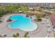 Aerial view of community pool with white lounge chairs, tables, and mature landscaping at 13822 Carlow Park Dr, Riverview, FL 33579