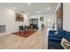 Open-concept dining room with sleek table, wood-look tile floors, and modern light fixtures offers a bright, inviting space at 13822 Carlow Park Dr, Riverview, FL 33579