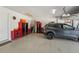 Garage with a vehicle, painted floor, storage cabinets, and garage door opener at 13822 Carlow Park Dr, Riverview, FL 33579