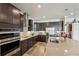Gourmet kitchen boasts stainless appliances, custom cabinets, and a spacious island, ideal for culinary enthusiasts at 13822 Carlow Park Dr, Riverview, FL 33579