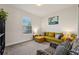 Comfortable living room features a plush yellow sectional sofa and natural light at 13822 Carlow Park Dr, Riverview, FL 33579