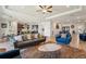 Inviting living room with comfortable seating, an open layout, and a glimpse of the modern kitchen at 13822 Carlow Park Dr, Riverview, FL 33579