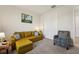 Cozy living room with a comfortable sofa and chair and a closet for storage at 13822 Carlow Park Dr, Riverview, FL 33579
