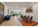 Expansive living room boasts ample seating, wood-look tile floors, and sliding glass doors to outdoor patio with lake views at 13822 Carlow Park Dr, Riverview, FL 33579