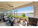 Covered patio with comfortable seating and a serene lake view at 13822 Carlow Park Dr, Riverview, FL 33579