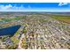 An aerial view displaying a community with multiple homes and a lake nearby, offering a sense of neighborhood and scenery at 15414 Fire Rock Pl, Ruskin, FL 33573