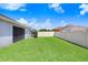 Large backyard featuring a well-maintained lawn and privacy fencing at 15414 Fire Rock Pl, Ruskin, FL 33573