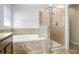 Bathroom with shower, soaking tub, and granite countertops at 15414 Fire Rock Pl, Ruskin, FL 33573