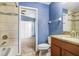 Bathroom featuring granite vanity top, tiled shower, and a view into the bedroom at 15414 Fire Rock Pl, Ruskin, FL 33573