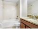 Bathroom featuring granite vanity top, tiled tub and shower, toilet, and tile floors at 15414 Fire Rock Pl, Ruskin, FL 33573