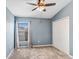 Well-lit bedroom with carpet flooring and standard double door closet at 15414 Fire Rock Pl, Ruskin, FL 33573