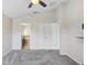 Bright bedroom with ensuite bath, plush carpet, and ceiling fan at 15414 Fire Rock Pl, Ruskin, FL 33573