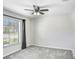 Bright bedroom featuring neutral walls, carpeted floors, a window, and a ceiling fan at 15414 Fire Rock Pl, Ruskin, FL 33573