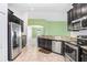 Modern kitchen featuring granite countertops, stainless appliances, tile floor, and breakfast bar at 15414 Fire Rock Pl, Ruskin, FL 33573