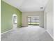 Open living room with vaulted ceilings, neutral paint, and large sliding doors at 15414 Fire Rock Pl, Ruskin, FL 33573