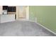 Spacious living room showcases light green walls and transitions into the kitchen and foyer at 15414 Fire Rock Pl, Ruskin, FL 33573