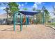 Community playground with swings, slides, and shaded seating area at 15414 Fire Rock Pl, Ruskin, FL 33573