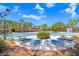 Resort-style community pool with lounge chairs and lush landscaping at 15414 Fire Rock Pl, Ruskin, FL 33573