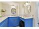 Vanity area in blue with double sinks and oval mirrors at 1600 Gulf Blvd # 817, Clearwater Beach, FL 33767
