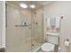 Well-lit bathroom featuring a glass-enclosed shower and modern toilet at 1600 Gulf Blvd # 817, Clearwater Beach, FL 33767