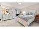 Bright bedroom with white furniture, decorative mirror, and access to the balcony at 1600 Gulf Blvd # 817, Clearwater Beach, FL 33767