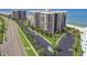 Scenic view of beachfront condos with private balconies, lush greenery, and ample parking spaces at 1600 Gulf Blvd # 817, Clearwater Beach, FL 33767