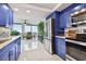 Contemporary kitchen features updated appliances, blue cabinets, and breakfast area at 1600 Gulf Blvd # 817, Clearwater Beach, FL 33767