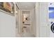 Hallway showing laundry area and bathroom with marble flooring at 1600 Gulf Blvd # 817, Clearwater Beach, FL 33767