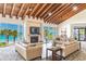 A stylish common area with ocean views, cozy seating, a fireplace, and a wood-beamed ceiling at 1600 Gulf Blvd # 817, Clearwater Beach, FL 33767