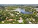 Aerial view of homes nestled around a lake with lush greenery at 16211 Villarreal De Avila, Tampa, FL 33613