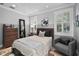 A cozy bedroom featuring a wood-accented headboard and stylish gray chair at 16211 Villarreal De Avila, Tampa, FL 33613