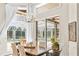Dining area with a view of the backyard pool and outdoor seating, perfect for entertaining and relaxation at 16211 Villarreal De Avila, Tampa, FL 33613