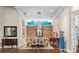 Formal dining room features wood floors, chairs around a large dining table, and decorative accent wall at 16211 Villarreal De Avila, Tampa, FL 33613