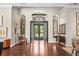 Grand entrance showcasing wood floors, arches, and french doors leading to the backyard at 16211 Villarreal De Avila, Tampa, FL 33613