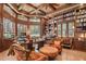 Stunning home office featuring custom wood built-ins, a coffered ceiling, and an abundance of natural light at 16211 Villarreal De Avila, Tampa, FL 33613