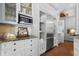Elegant kitchen with custom cabinetry, stainless steel appliances, granite counters, and wood floors at 16211 Villarreal De Avila, Tampa, FL 33613