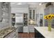 Gourmet kitchen showcasing stainless steel appliances, custom cabinets, and a center island with seating at 16211 Villarreal De Avila, Tampa, FL 33613