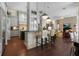 Open kitchen featuring modern appliances, sleek countertops, a breakfast bar, and stylish lighting at 16211 Villarreal De Avila, Tampa, FL 33613