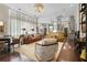 Inviting living room featuring hardwood floors, modern lighting, and seamless open floorplan to kitchen and dining at 16211 Villarreal De Avila, Tampa, FL 33613